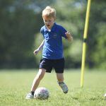 boy running with a ball