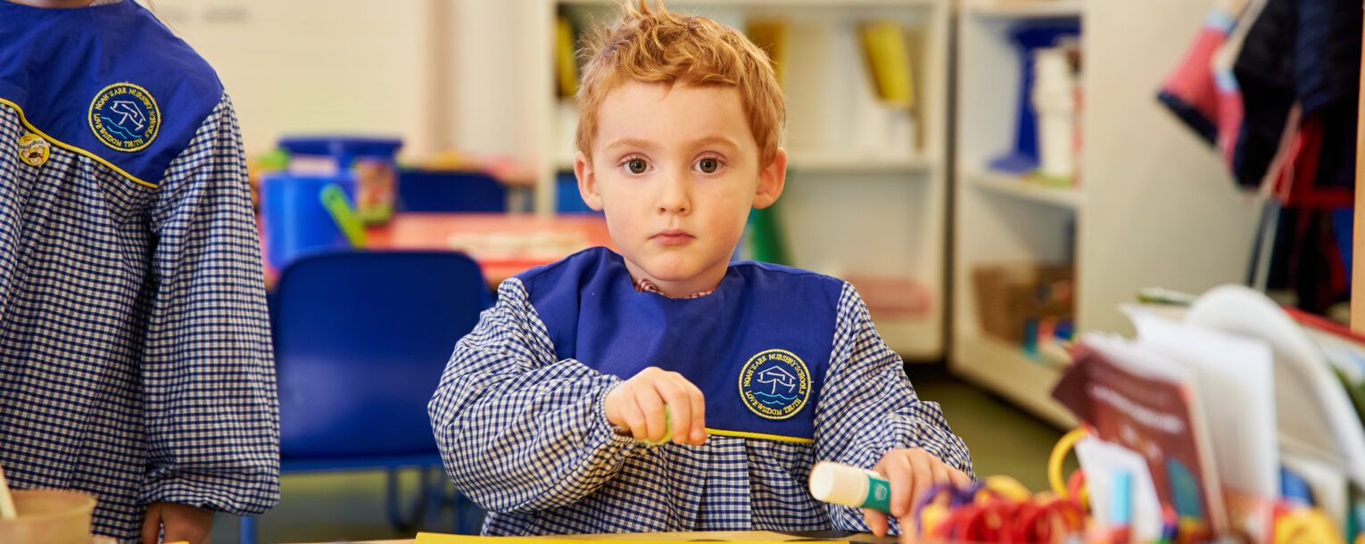 child holding glue stick