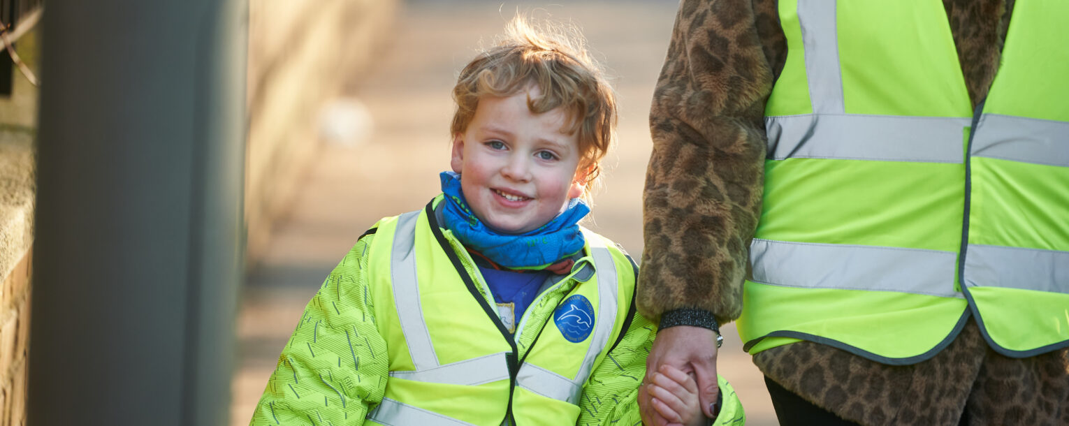 boy holding teacher hand